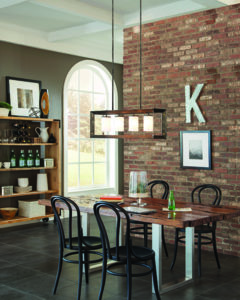 Pendant Lighting Transitional CHATAUQUA Feiss 6640504-846 over a wooden kitchen table next to a brick wall