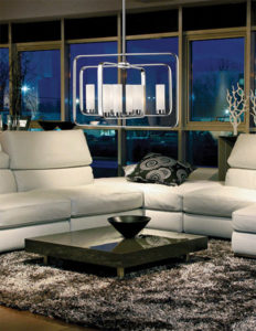 Luminaire suspendu transitionnel AIDEEN Z-Lite 6000-8A-CH allumé dans un salon avec divan en cuir blanc